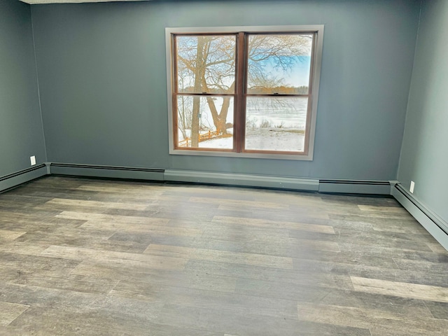 unfurnished room featuring a baseboard radiator and wood finished floors