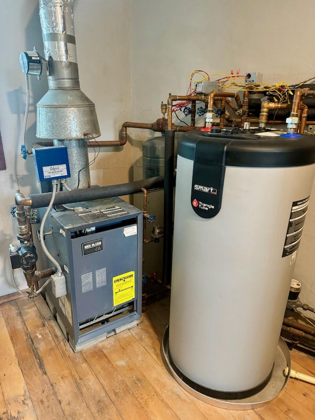 utility room featuring water heater and a heating unit