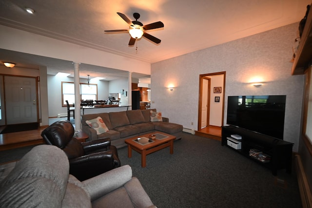 living area featuring a ceiling fan, a baseboard heating unit, and baseboards