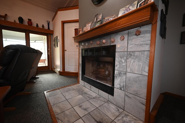 interior space with baseboard heating, crown molding, and a tile fireplace