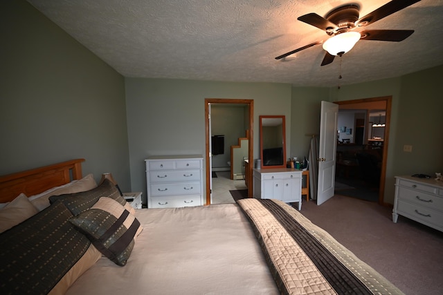 carpeted bedroom with ceiling fan and a textured ceiling