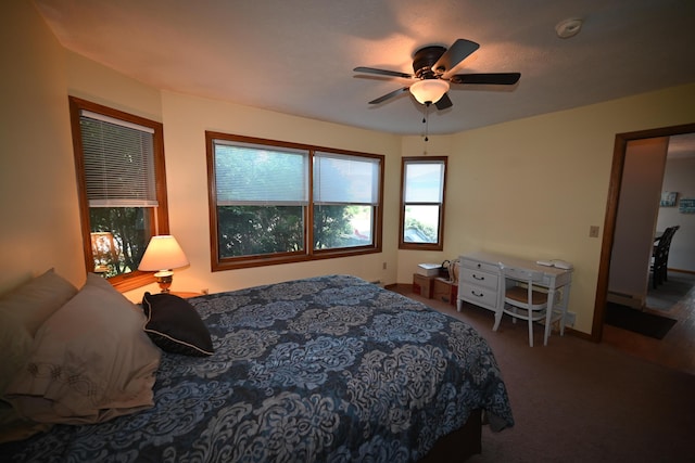 carpeted bedroom featuring ceiling fan and a baseboard radiator