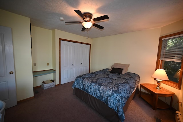 bedroom with visible vents, a ceiling fan, carpet floors, a baseboard heating unit, and a closet