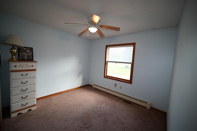 empty room featuring ceiling fan, baseboard heating, carpet flooring, and baseboards