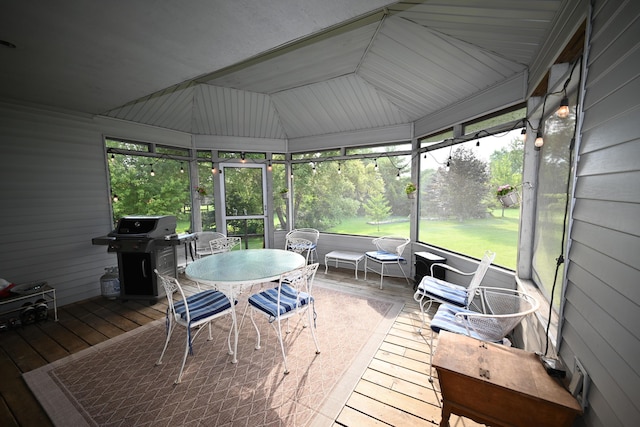 sunroom / solarium featuring lofted ceiling