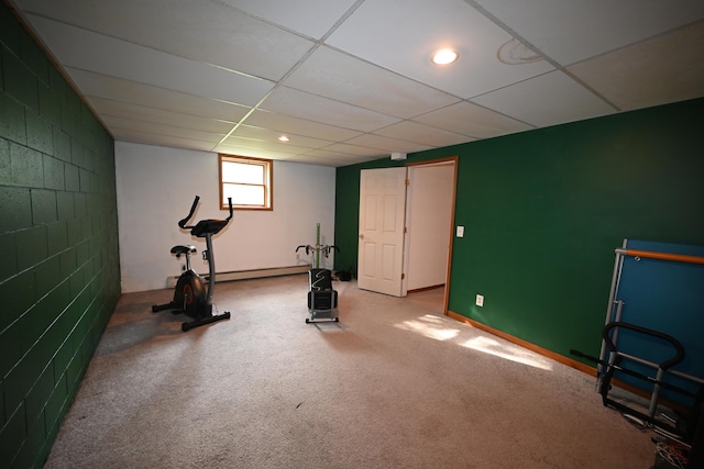 workout area featuring concrete block wall, a baseboard heating unit, a drop ceiling, and recessed lighting