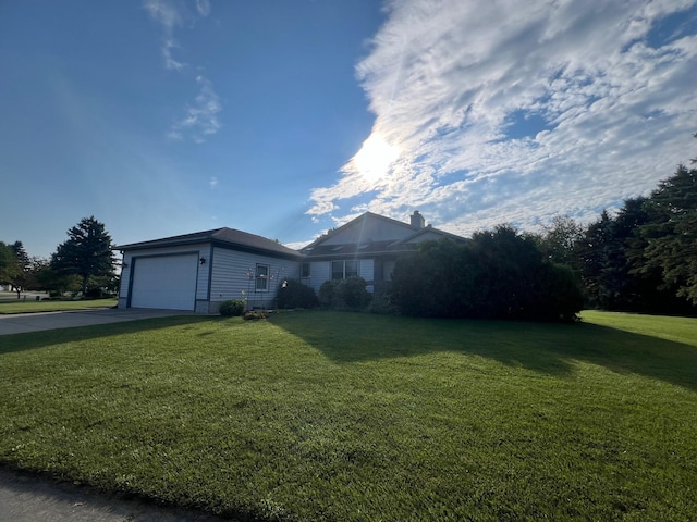 ranch-style home with a front lawn, concrete driveway, and an attached garage