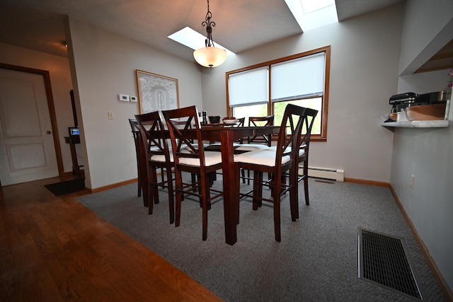 dining area featuring a baseboard radiator, visible vents, baseboards, and wood finished floors