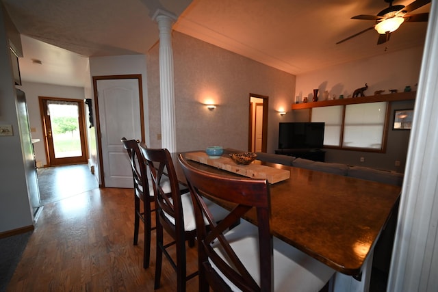 dining room featuring decorative columns, a ceiling fan, and wood finished floors