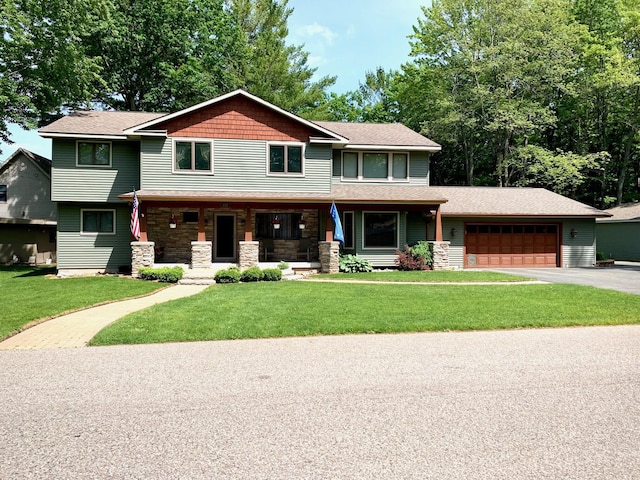 craftsman house with aphalt driveway, a porch, an attached garage, a front yard, and stone siding