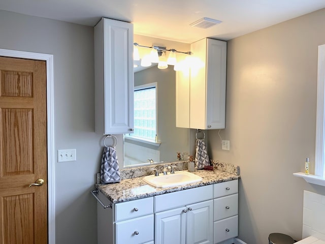 bathroom with visible vents and vanity