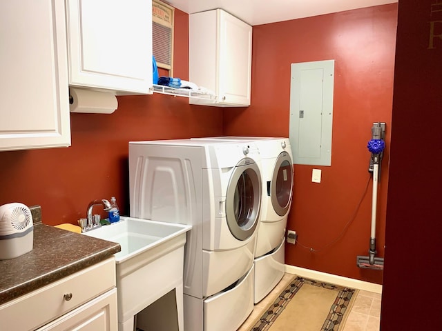 laundry room featuring electric panel, cabinet space, washer and clothes dryer, and baseboards