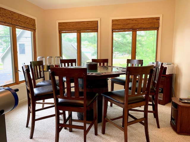 dining area featuring plenty of natural light and light colored carpet