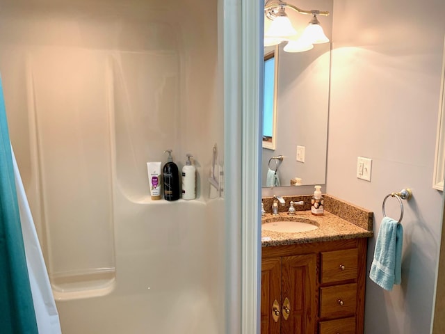 bathroom featuring vanity and a shower with shower curtain