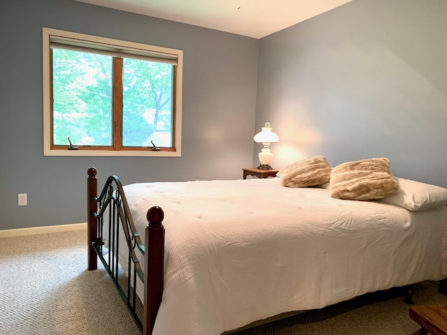 bedroom featuring carpet and baseboards