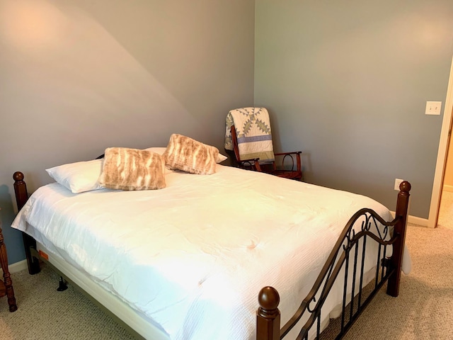 bedroom featuring baseboards and carpet flooring