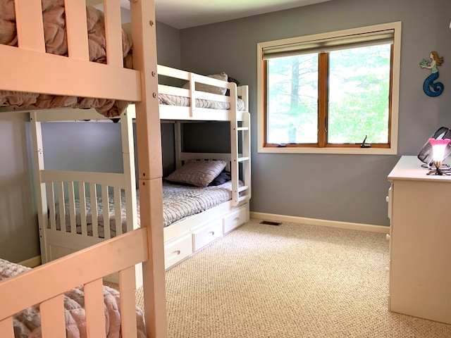 carpeted bedroom featuring baseboards