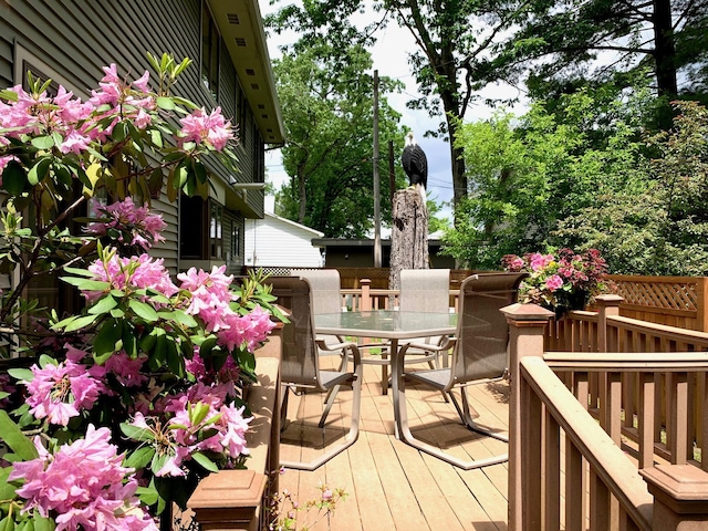 wooden deck featuring outdoor dining area