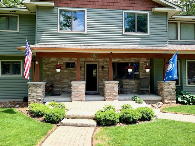 view of front facade featuring covered porch and stone siding