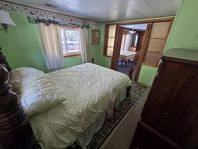 bedroom featuring carpet and visible vents