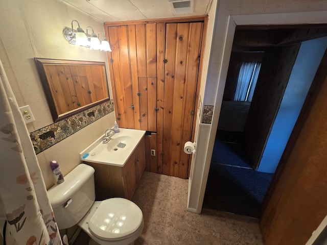 bathroom featuring toilet, visible vents, and vanity