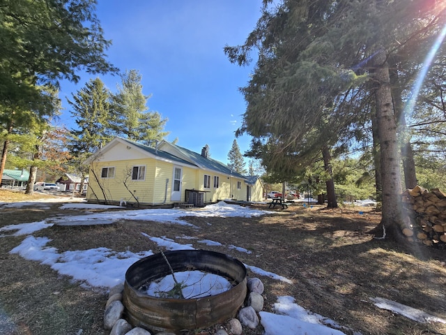 exterior space featuring a chimney and central air condition unit