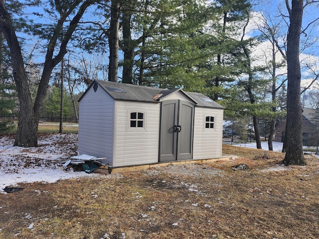 view of shed featuring fence