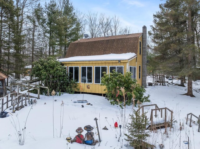 view of front of property with a shingled roof, board and batten siding, and a gambrel roof