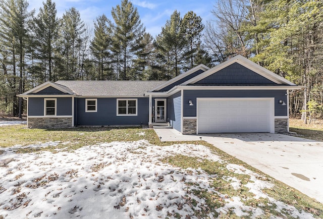 view of front of property featuring concrete driveway, an attached garage, and stone siding