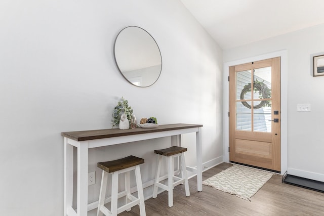 entrance foyer with baseboards and wood finished floors