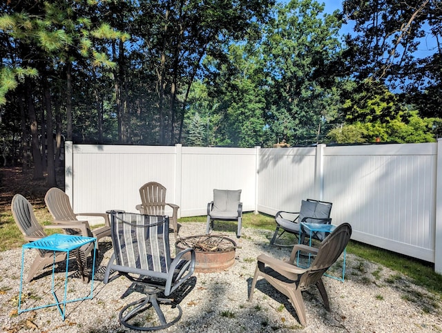 view of yard featuring an outdoor fire pit and fence