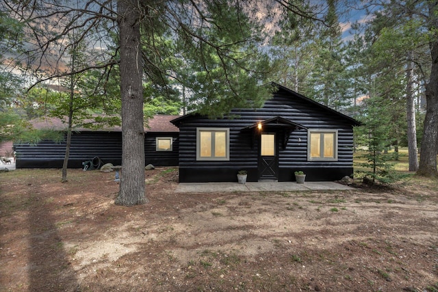 rear view of property with log veneer siding