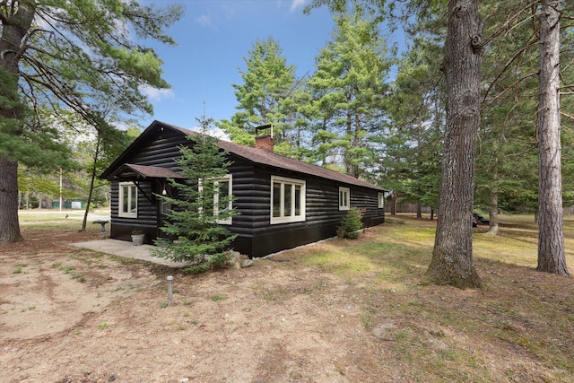 view of side of property with a chimney