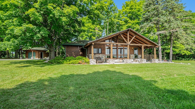 rear view of property with stone siding and a yard