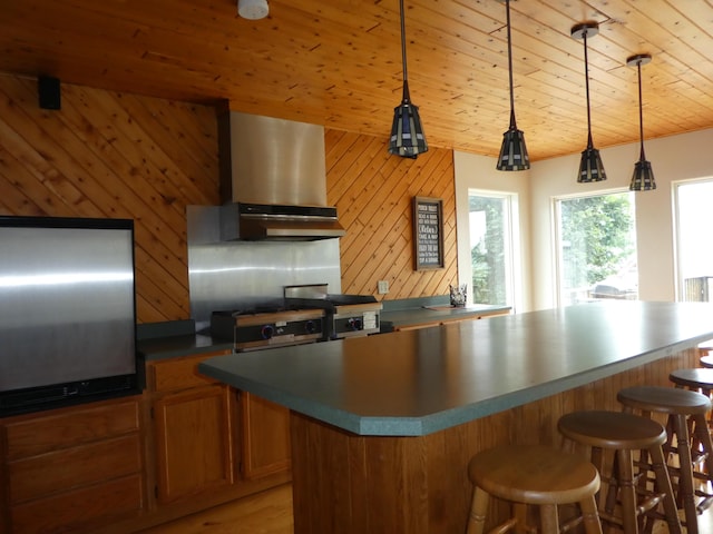 kitchen featuring extractor fan, wooden ceiling, pendant lighting, and a center island