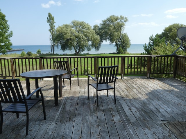 deck featuring a lawn and a water view