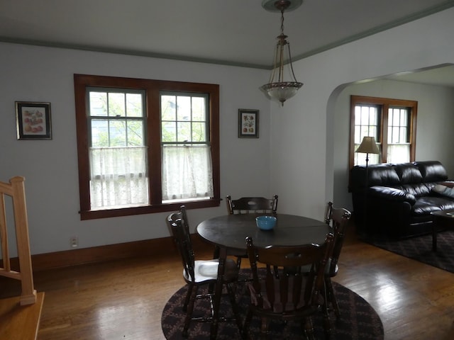 dining area featuring crown molding and hardwood / wood-style floors