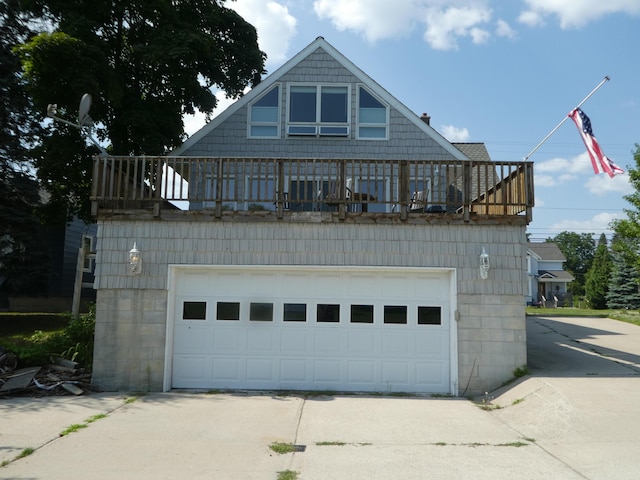 view of front of house featuring a balcony and a garage