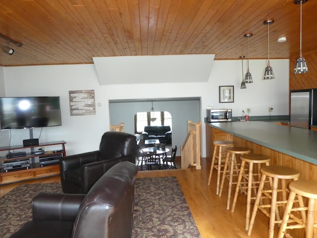 living room with indoor bar, wood ceiling, and light hardwood / wood-style flooring