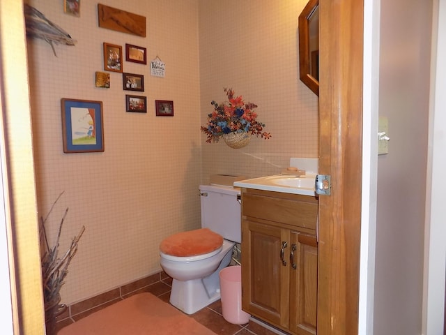 bathroom featuring vanity, tile floors, and toilet