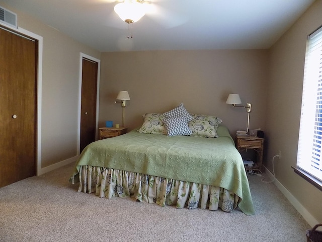 carpeted bedroom featuring ceiling fan and a closet