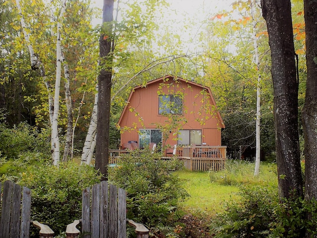 back of property featuring a wooden deck