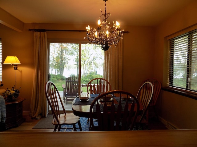 dining space featuring dark hardwood / wood-style flooring and an inviting chandelier