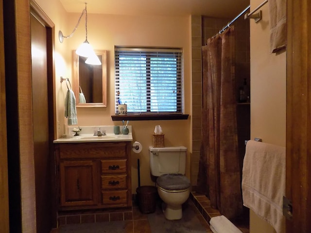 bathroom with toilet, vanity, and tile flooring