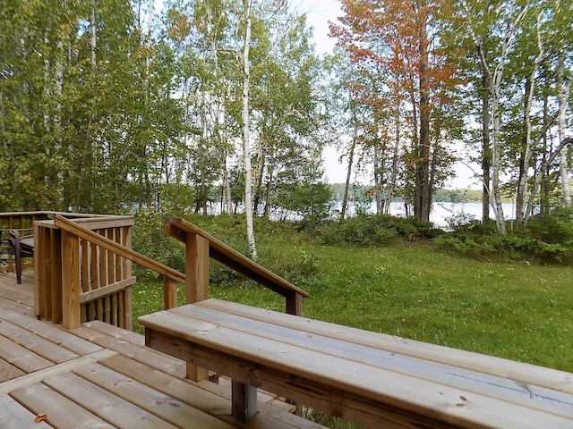 deck featuring a water view and a lawn