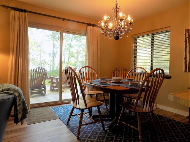 dining space with an inviting chandelier and hardwood / wood-style floors