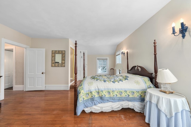 bedroom featuring dark hardwood / wood-style floors and vaulted ceiling