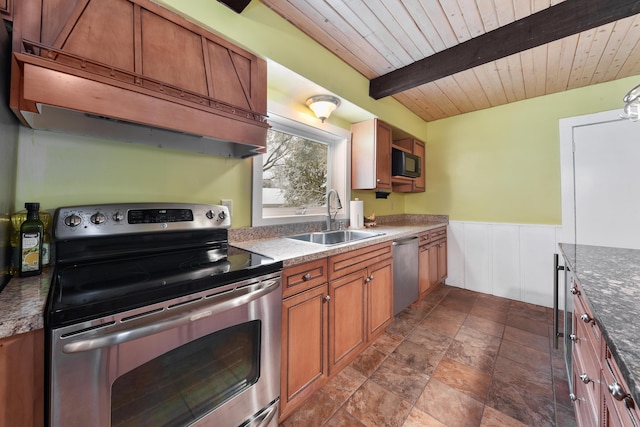 kitchen with wooden ceiling, appliances with stainless steel finishes, dark tile floors, sink, and beam ceiling