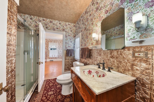 bathroom featuring tile walls, toilet, vanity, and wood-type flooring