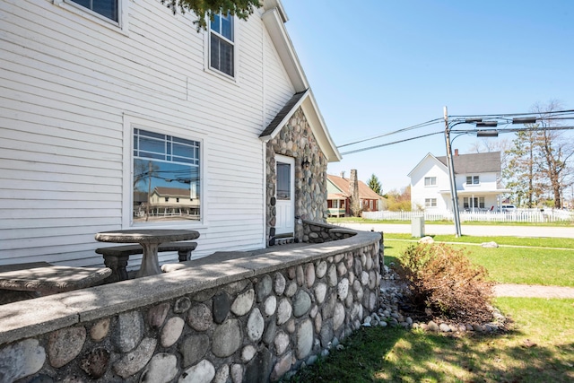 view of side of property with a lawn